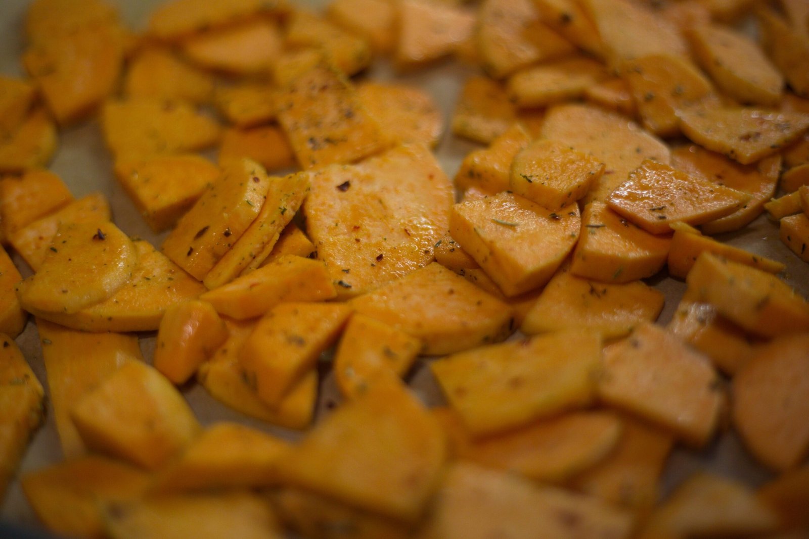 High-angle view of seasoned sweet potato slices, perfect for healthy cooking.